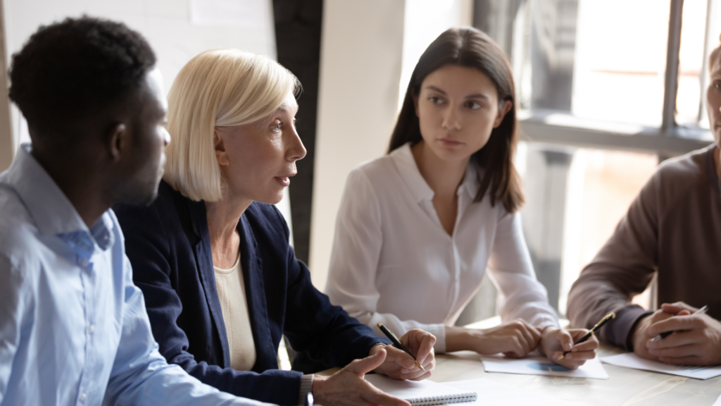 Employees talking at a conference table