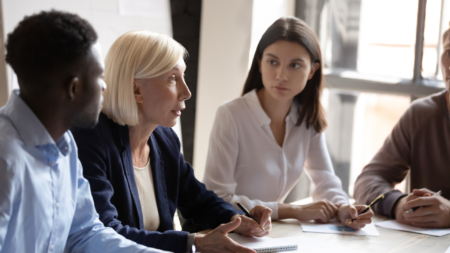 Employees talking at a conference table