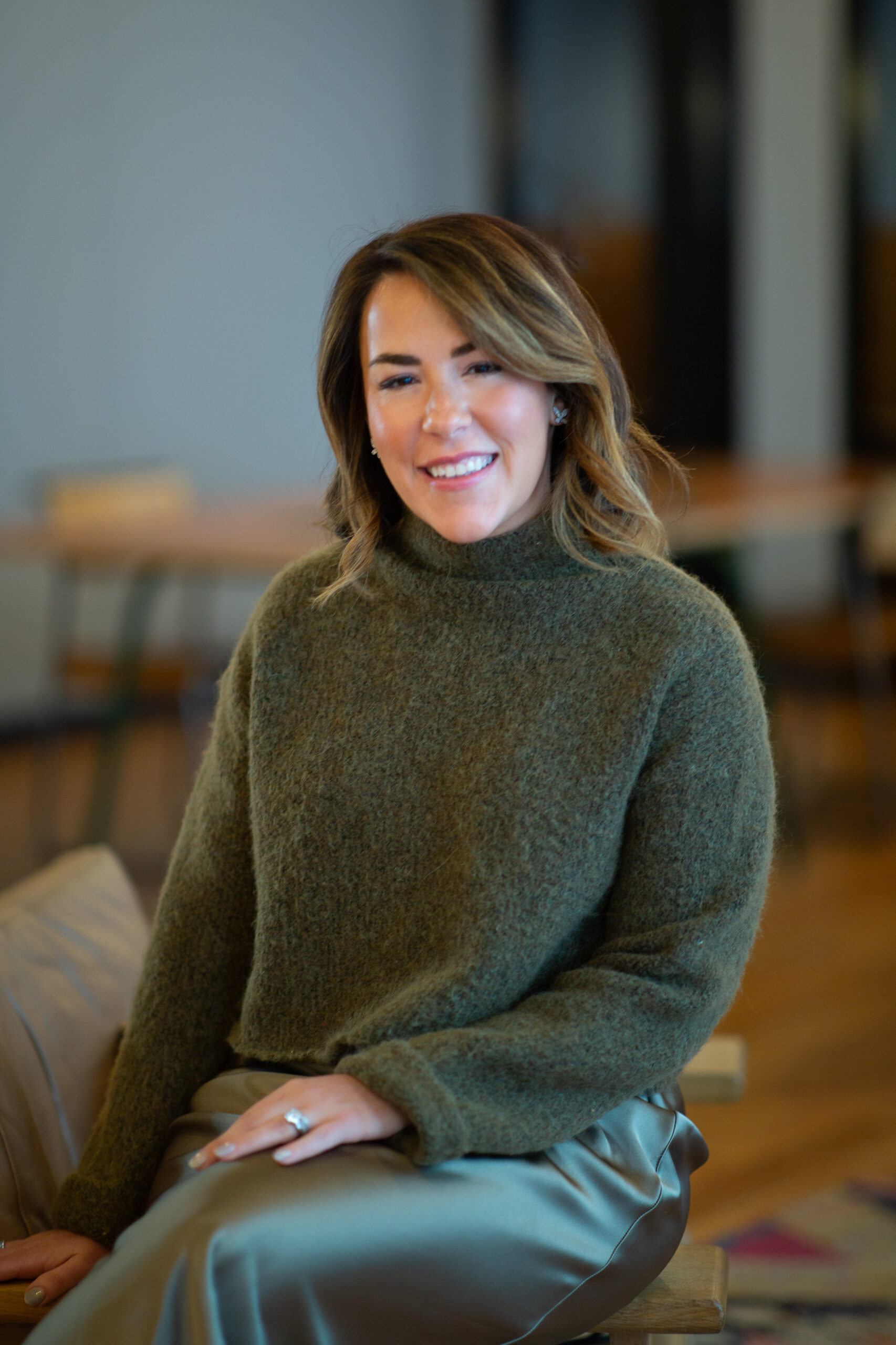 Celia Balson sitting on arm of chair