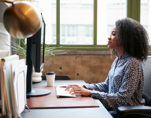 Woman typing at desk