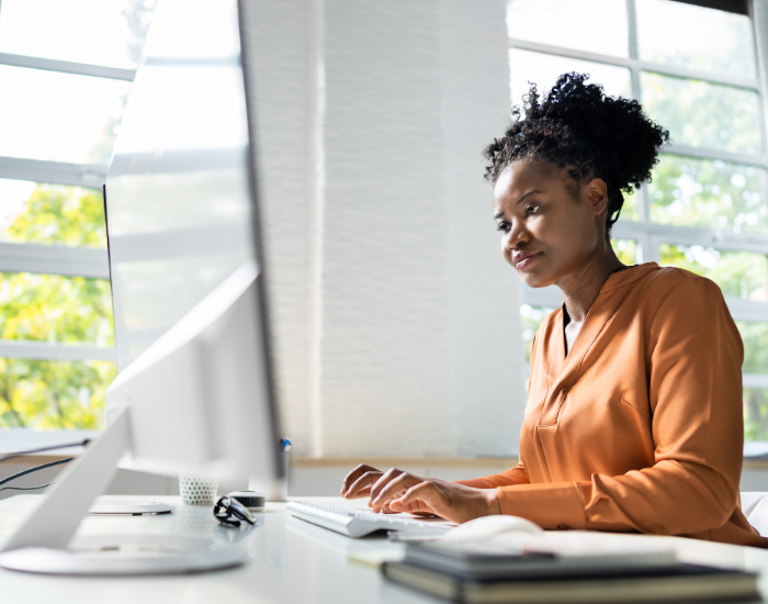 Woman sitting at computer typing